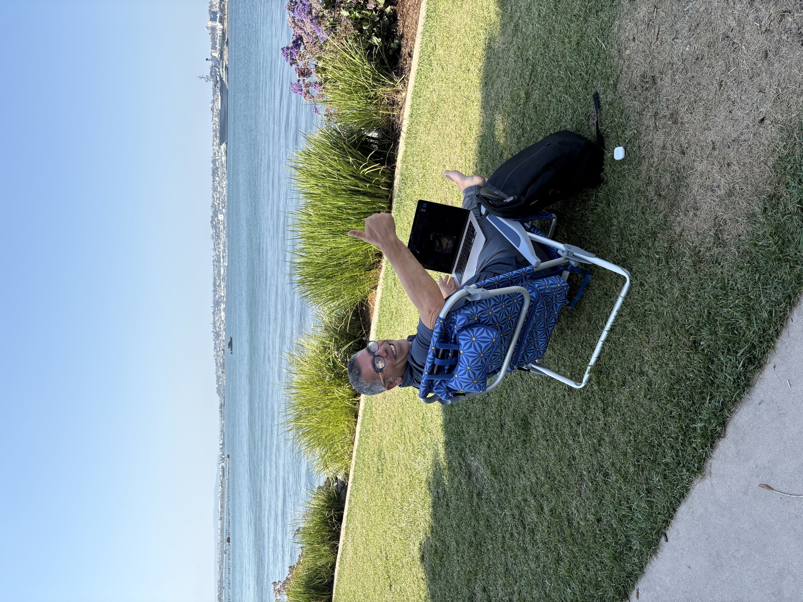 Buddy working from a beach chair by the water